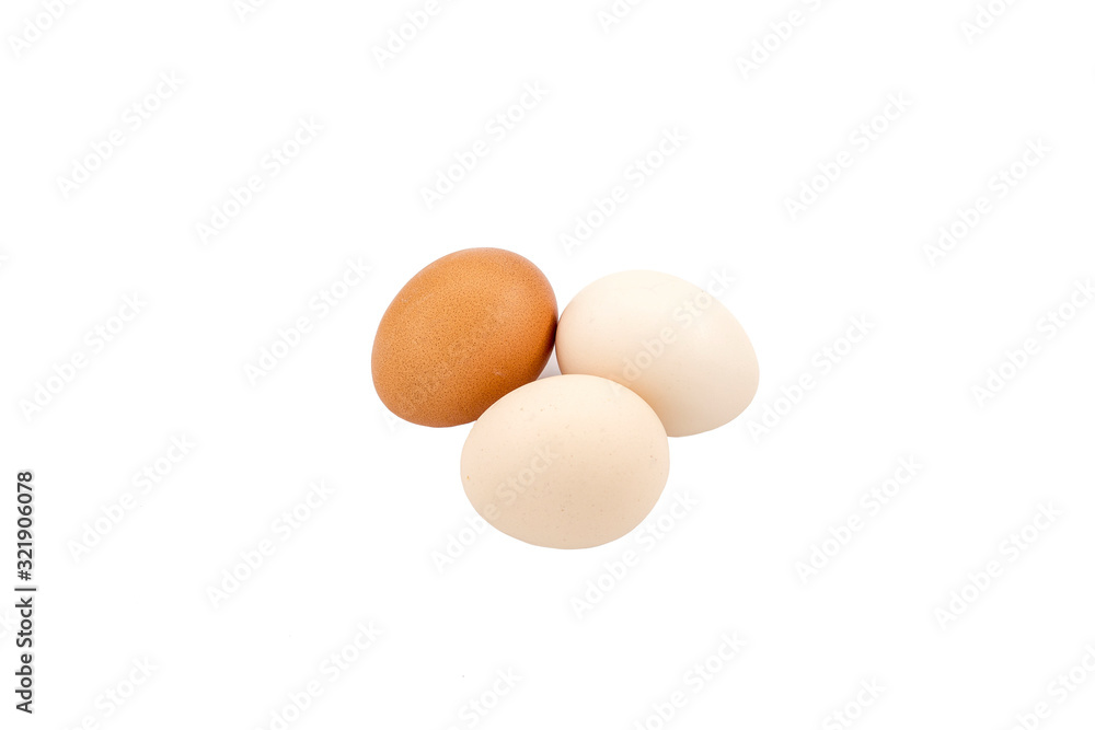 White and brown eggs on white ground White and brown eggs on white ground