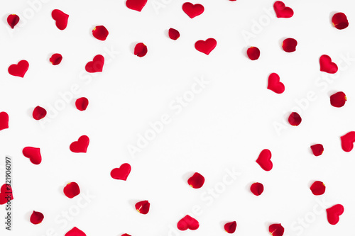 Elegant composition for Valentine's Day. Red hearts, rose petals on white background. Valentine day, 8th march, Mother day background. Love concept. Flat lay, top view, copy space