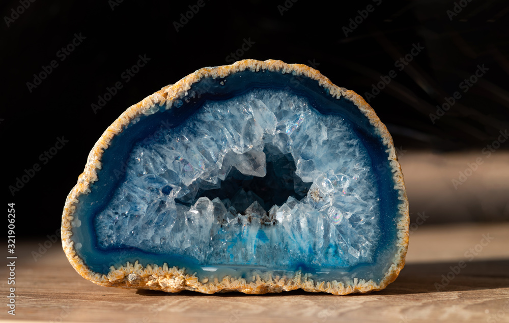Geode with transparent crystals of light-blue color on a dark background.. - obrazy, fototapety, plakaty 