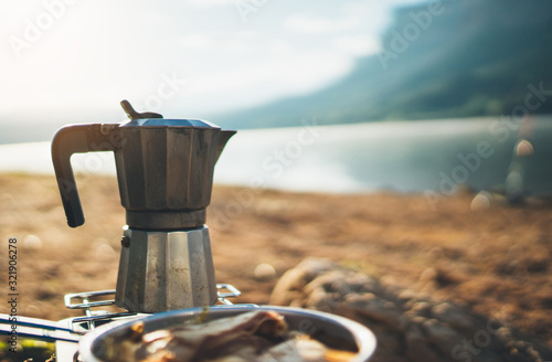 moka pot coffee outdoor, campsite morning picnic lifestyle, person cooking hot drink in nature camping, cooker prepare breakfast, tourism recreation outside
