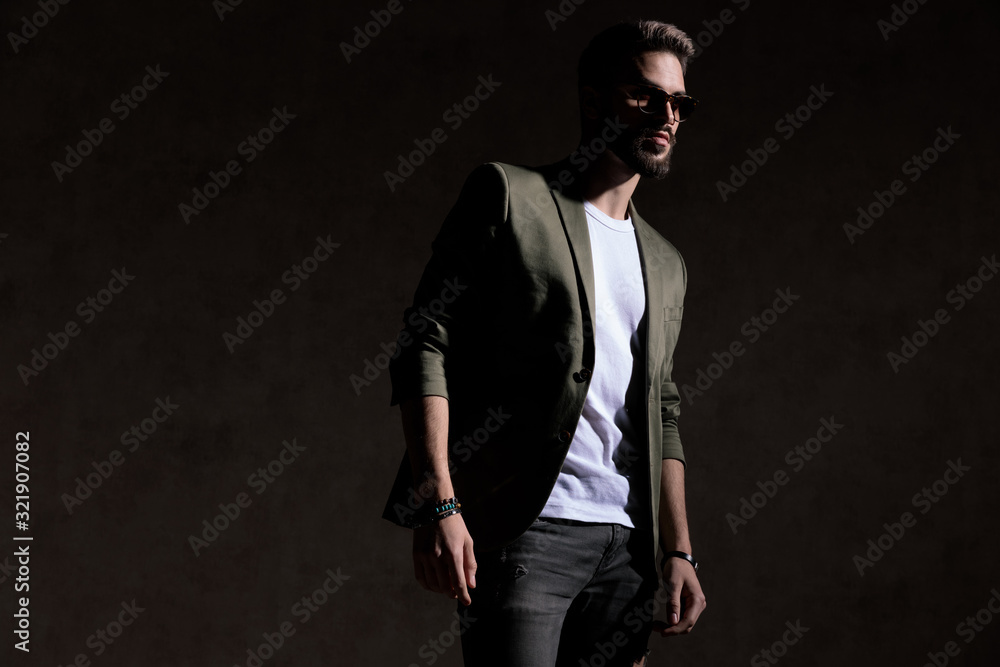 cool young model wearing glasses and posing in a fashion light