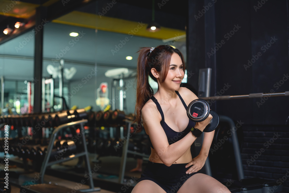 Women exercising at the gym and have a watch for exercising. Women exercising at the gym and have a watch for exercising.