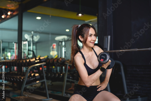 Women exercising at the gym and have a watch for exercising.
