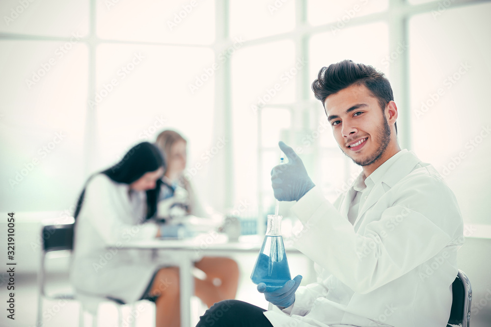 Fototapeta premium smiling young scientist researching a coronavirus vaccine