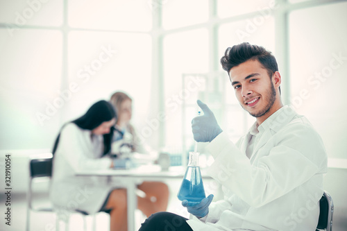 smiling young scientist researching a coronavirus vaccine