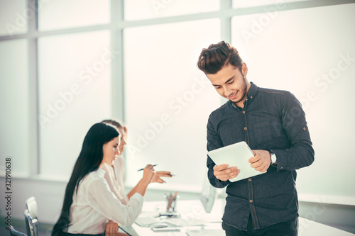 young businessman with digital tablet standing in office.