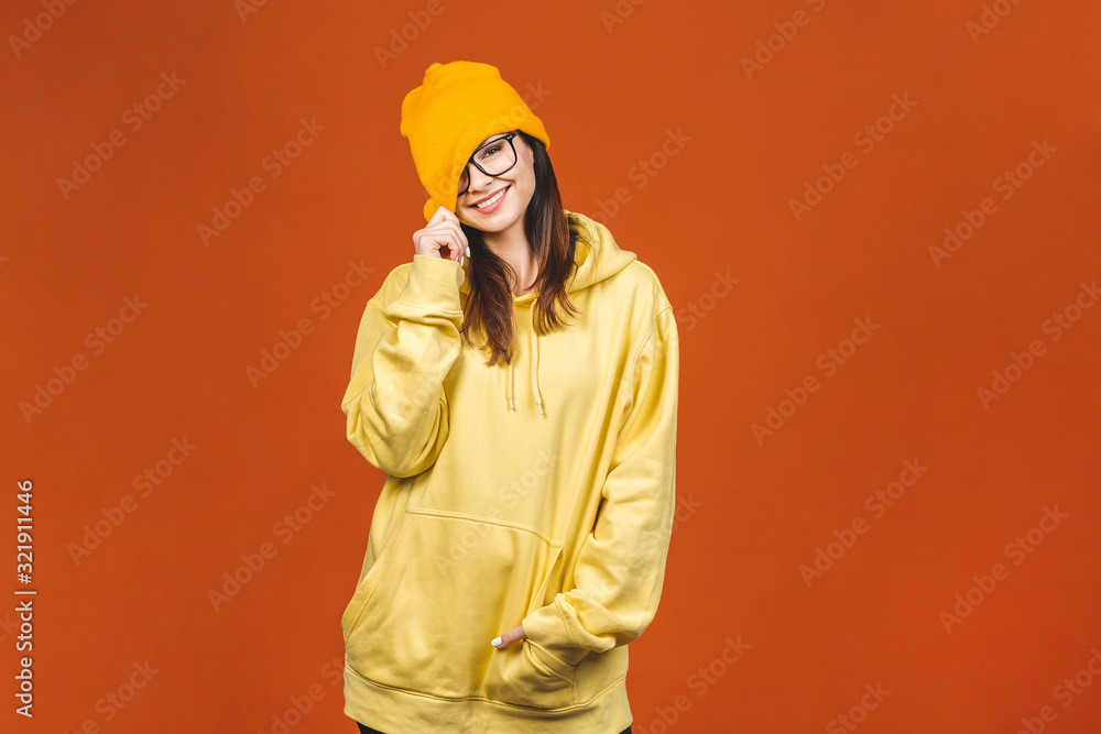 People, youth, leisure and lifestyle concept. Fashionable beautiful young Caucasian young female student wearing stylish clothing laughing, pointing finger. Isolated over orange. People, youth, leisure and lifestyle concept. Fashionable beautiful young Caucasian young female student wearing stylish clothing laughing, pointing finger. Isolated over orange.