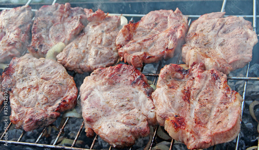 Steak on barbecue. Preparation appetizing pork outside Steak on barbecue. Preparation appetizing pork outside