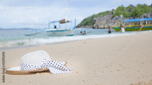 Hat on a white sandy beach. White sand. Sea traveling.