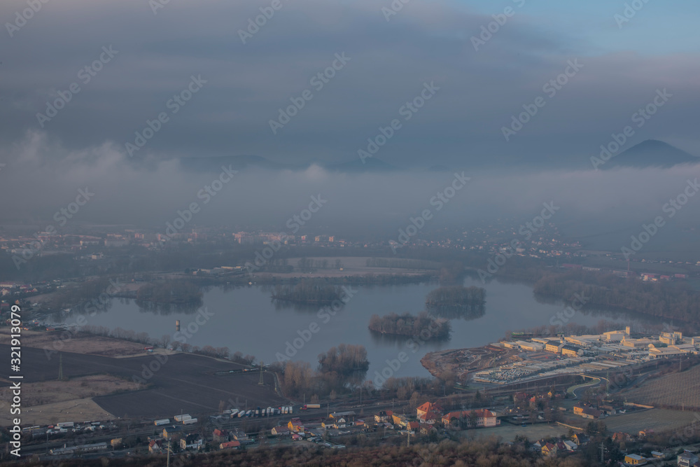 Sunrise time on Radobyl hill over valley of river Labe and Lovosice town