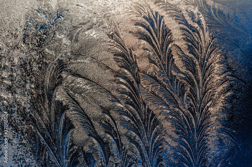 Beautiful ice pattern on winter glass, natural texture. Background.