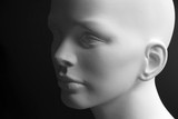 White mannequin head with neutral face expression and dark background