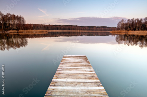 Old wooden footbridge on the lake © roobcio