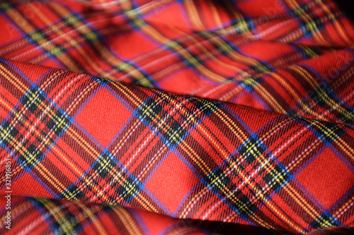 Red tartan fabric close up 