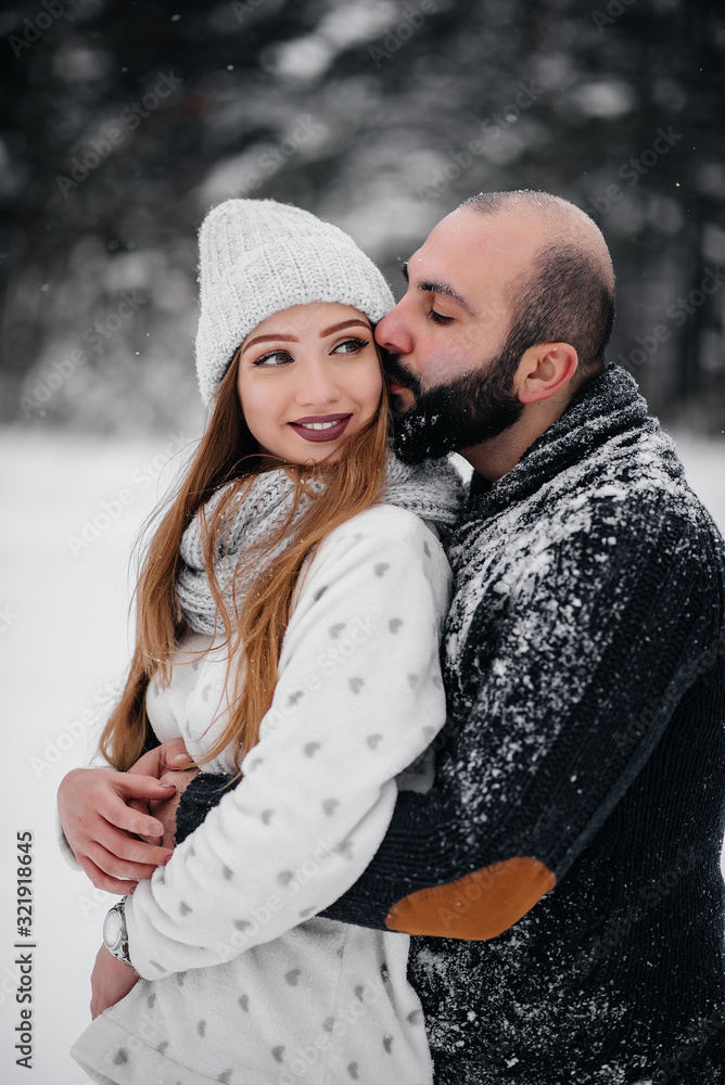 Fototapeta premium Couple playing with snow in the forest
