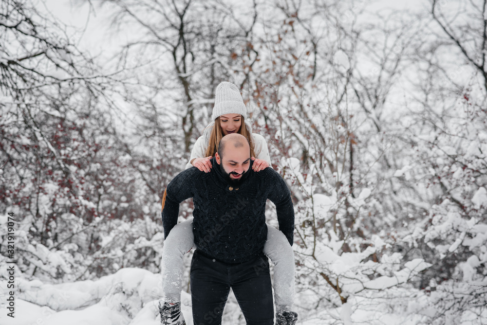 Couple playing with snow in the forest Couple playing with snow in the forest