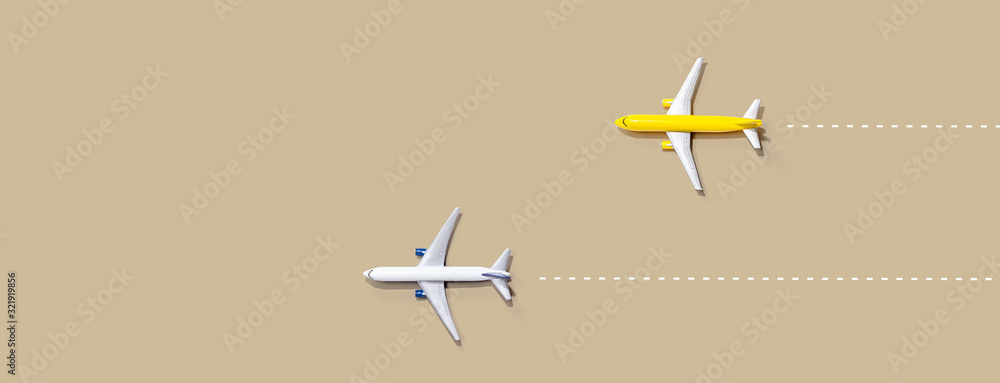 Fototapeta Flights booking and reservation theme with two miniature airplanes