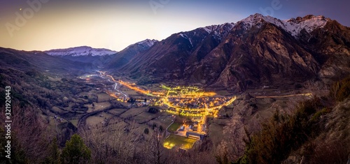 Beautiful village in sunset light with snowy mountains background in Benasque, Spain