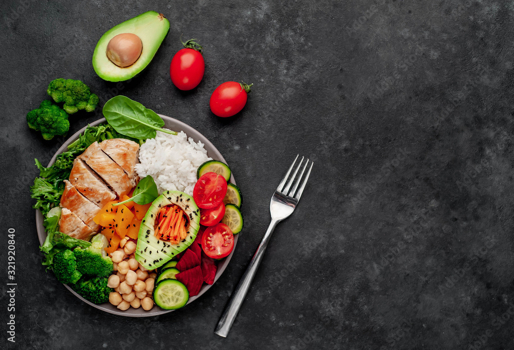 Bowl Buddha. rice, chicken breast, broccoli, pumpkin, avocado, chickpeas, carrots, cucumber, beets, a stone background with copy space for your text Bowl Buddha. rice, chicken breast, broccoli, pumpkin, avocado, chickpeas, carrots, cucumber, beets, a stone background with copy space for your text