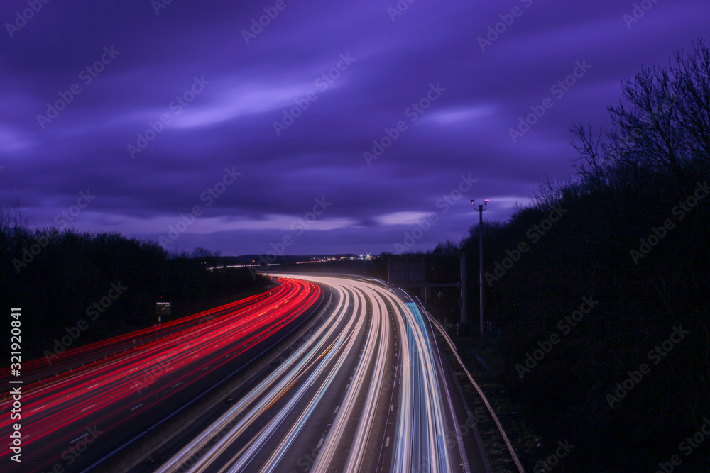traffic on highway at night with light trails on the m1