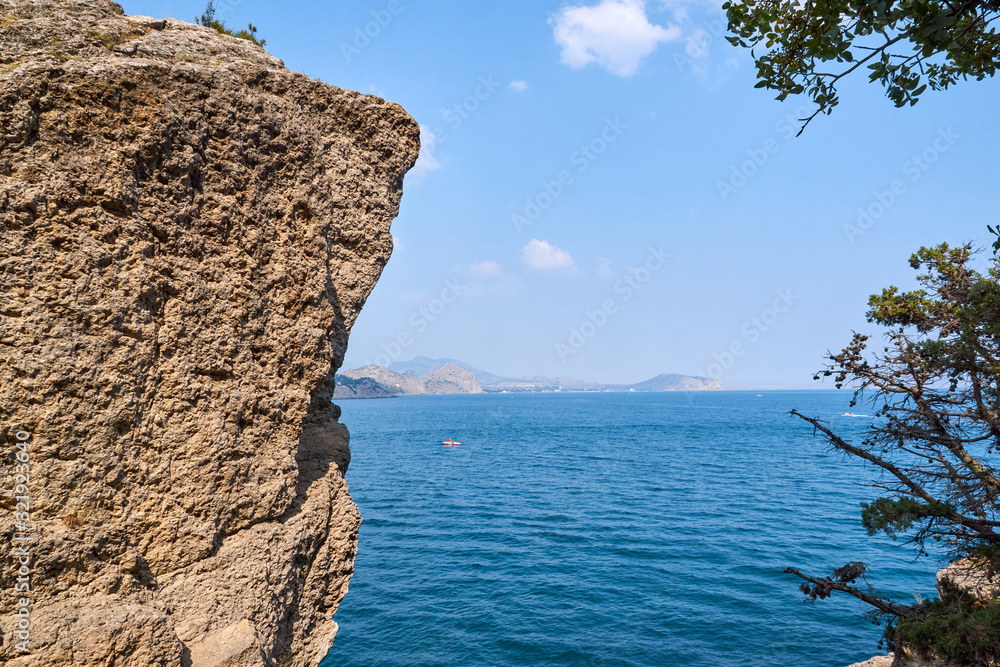 View of Green Bay, coastal cliffs and a ridge of mountains on the horizon. Black Sea coast, Sudak region, Republic of Crimea