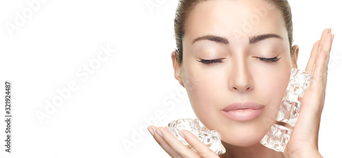 Spa Face Woman applies ice cubes on face. Healthy clean skin. Cold Beauty Treatments photo