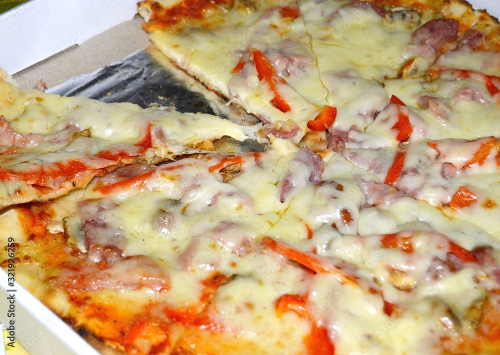 Ready pizza with ham in a hill. Ready pizza with ham in a hill.