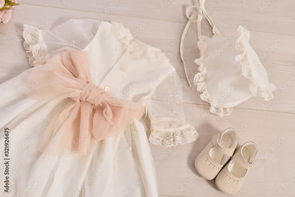christening baby dress. Close-up of a cute newborn baby dress. Stylish embroidered white dress. Concept childhood education and fashion christening baby dress. Close-up of a cute newborn baby dress. Stylish embroidered white dress. Concept childhood education and fashion