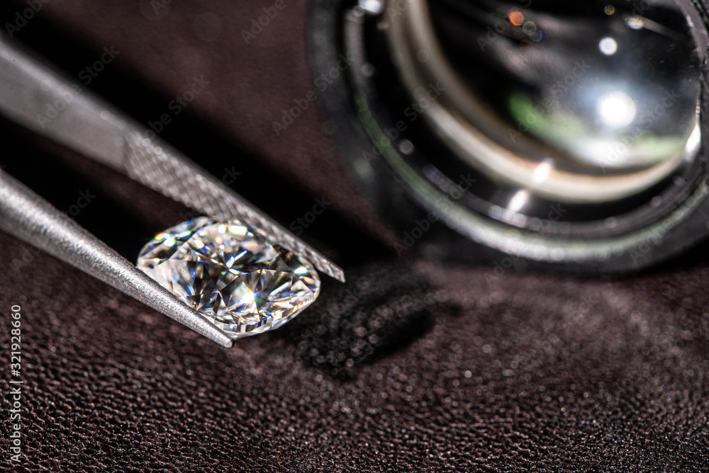 Diamond in Tweezers Closeup Diamond in Tweezers Closeup