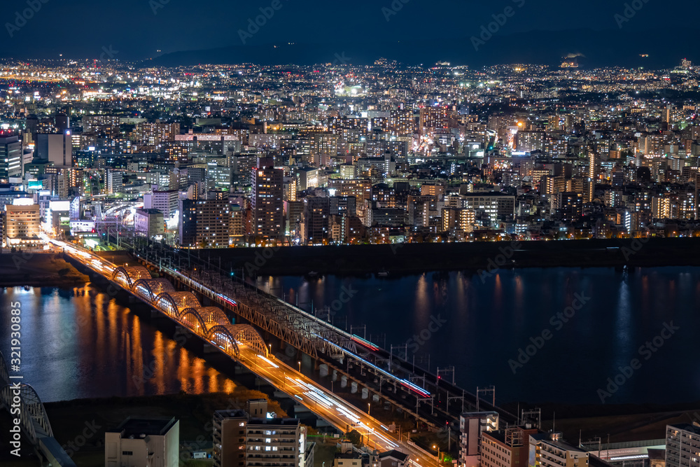 Japan. Osaka. Evening panorama of the big city. Bridges over the Yodo river. A huge city in the dark time. The lights of the big city. Guide to Japan. Japanese landscapes. Urbanistics.