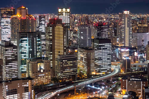 Japan. Osaka. Evening panorama of the big city. View of Osaka business center from a height. Buildings with glowing Windows and roads. Cities of Japan. Modern urban architecture.