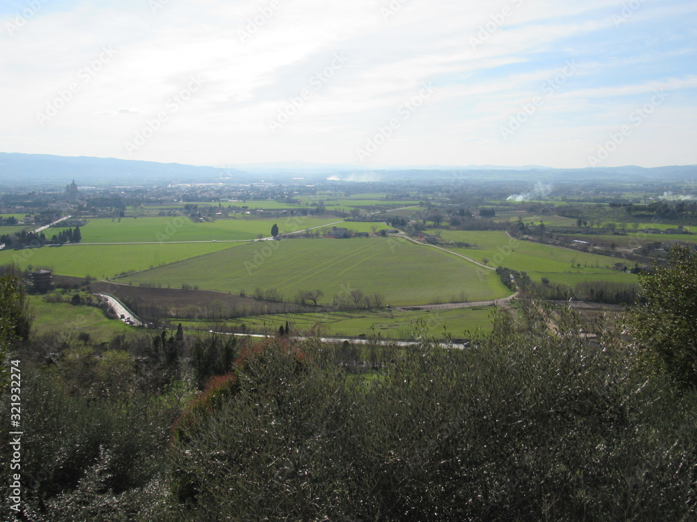View from an overlook at hills, valleys, and towns as seen from Assisi, Italy