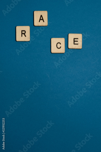 Race: Square wooden letters on blue background