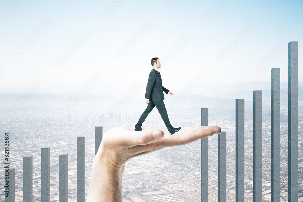 Hand helps a businessman climb on a business char