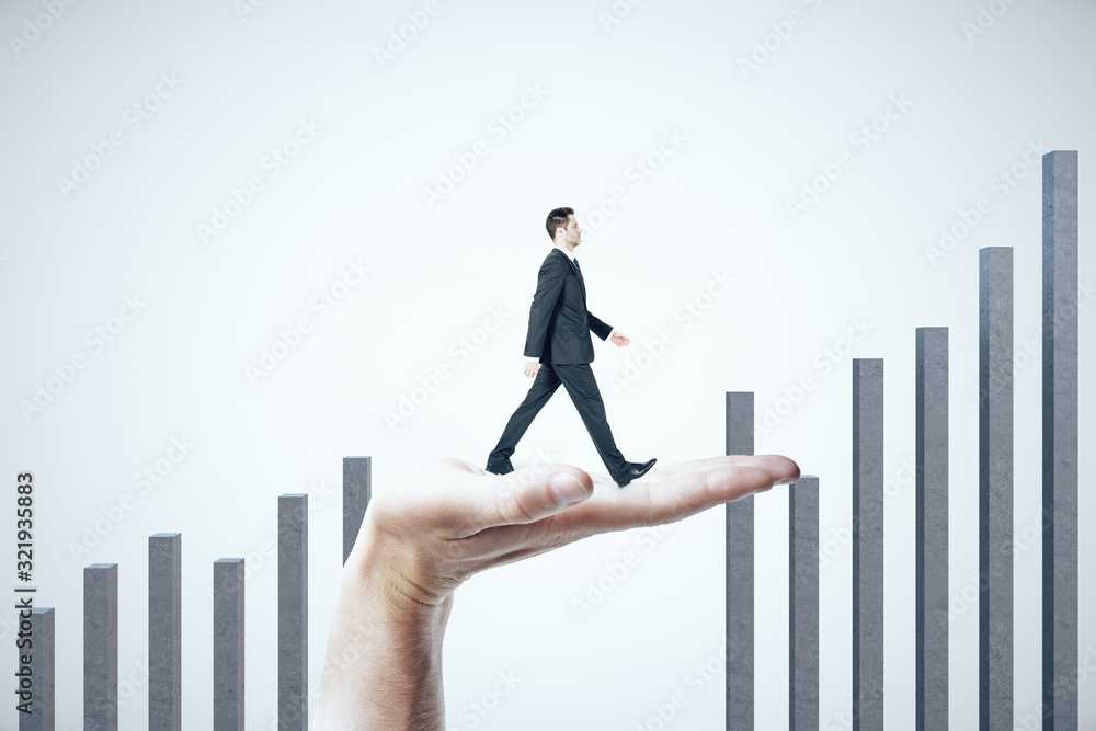 Hand helps a businessman climb on a business graph on white background. Hand helps a businessman climb on a business graph on white background.