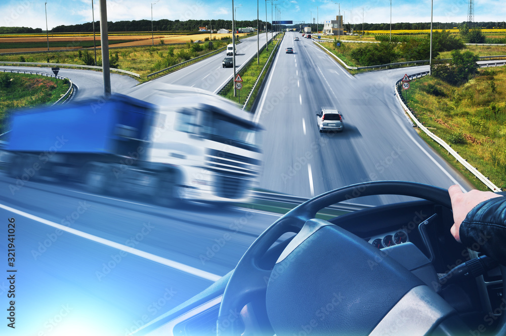 Fototapeta premium Abstract background with a truck in motion, truck steering wheel and a road with cars and a sky with blue lights