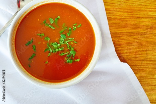 A bowl of tomato vegetable soup at an Indian restaurant