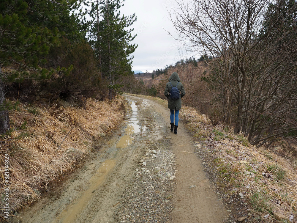 young woman walking in a forest pathway