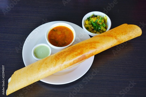 A plate with masala dosa bread stuffed with potatoes at an Indian restaurant