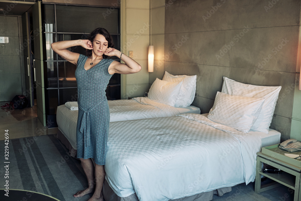 Obraz premium Woman stretches from tiredness, it's time to go to sleep.