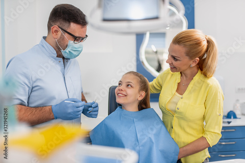 Dentist examining a patient s teeth in the dentist office