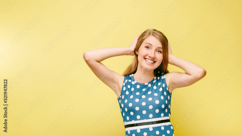 cheerful girl in dress holding her hair cheerful girl in dress holding her hair