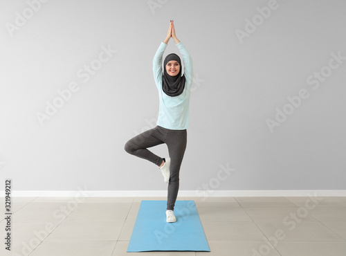 Sporty Muslim woman practic...