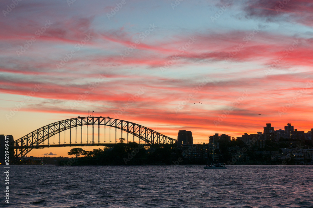 Sydney Harbour Bridge landmark against colorful sunset sky