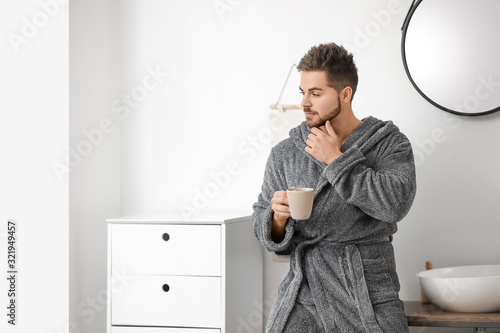 Handsome young man drinking...