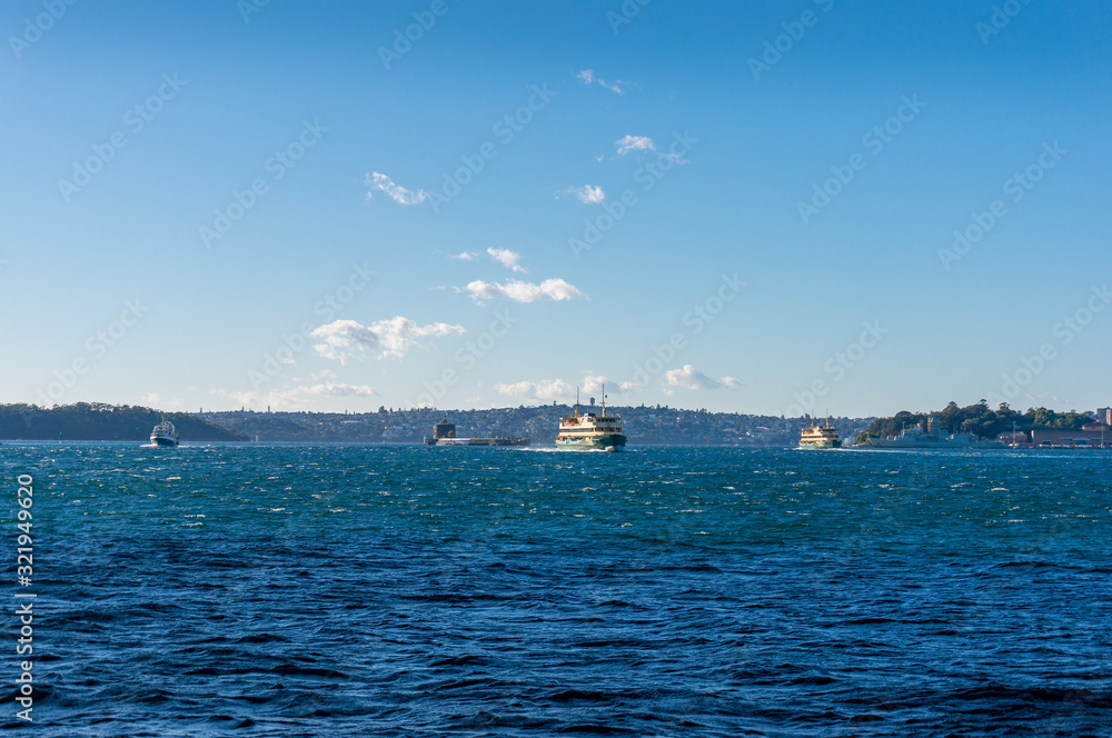Ferries and boats at Sydney Harbour with view of Historic Fort Denison