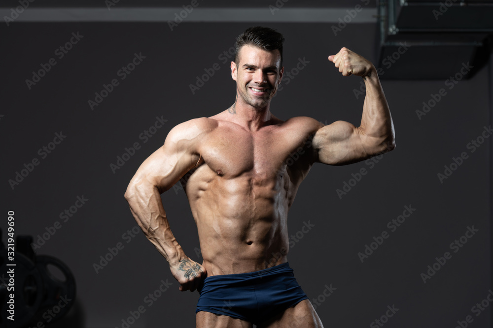 Bodybuilder Fitness Model Posing Biceps After Exercises