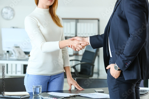 Bank manager and woman shak...