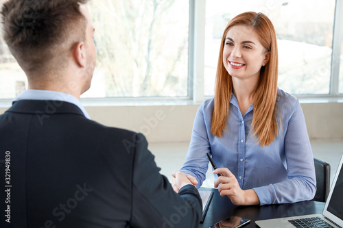 Bank manager and woman shak...