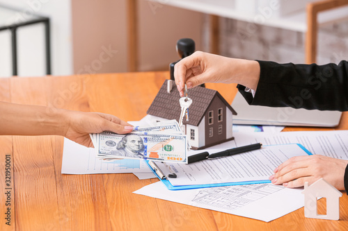 Real estate agent with key ...